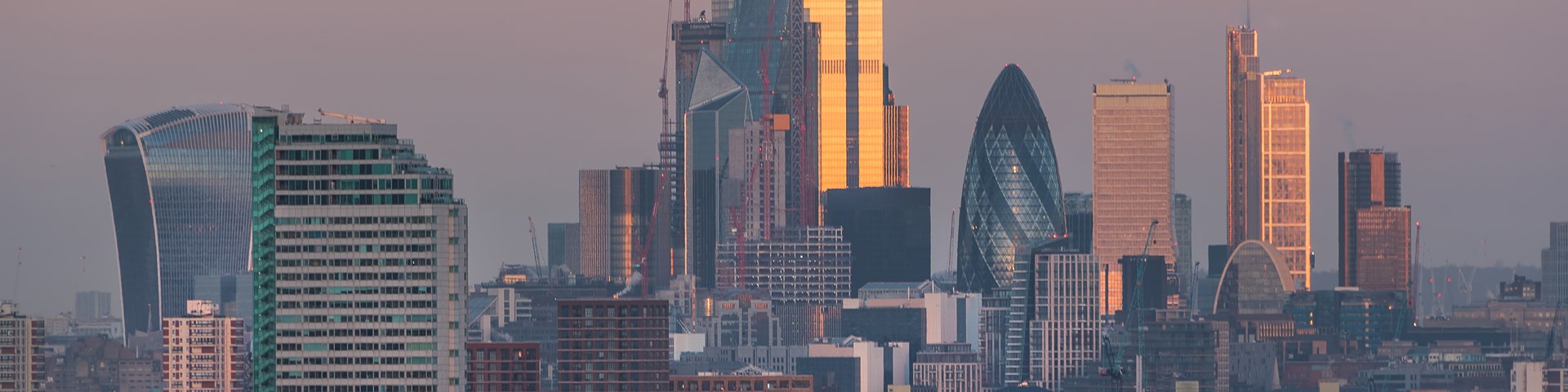 Sunrise over London financial district skyline buildings